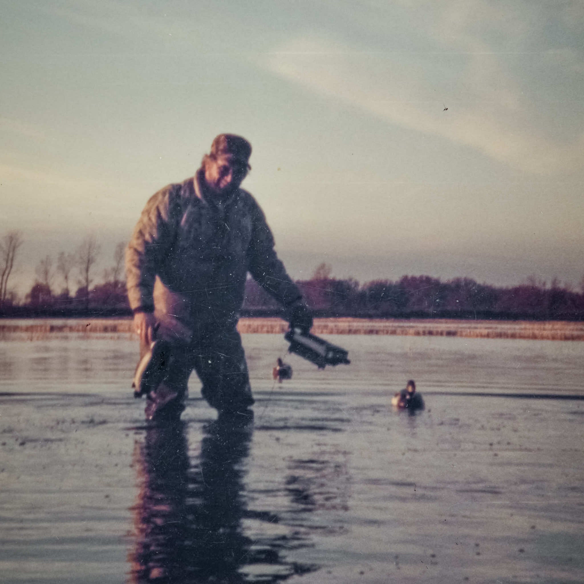 Rick Hampton moving decoys in Arkansas rice field at Two Rivers Duck Club in Brasfield, Arkansas