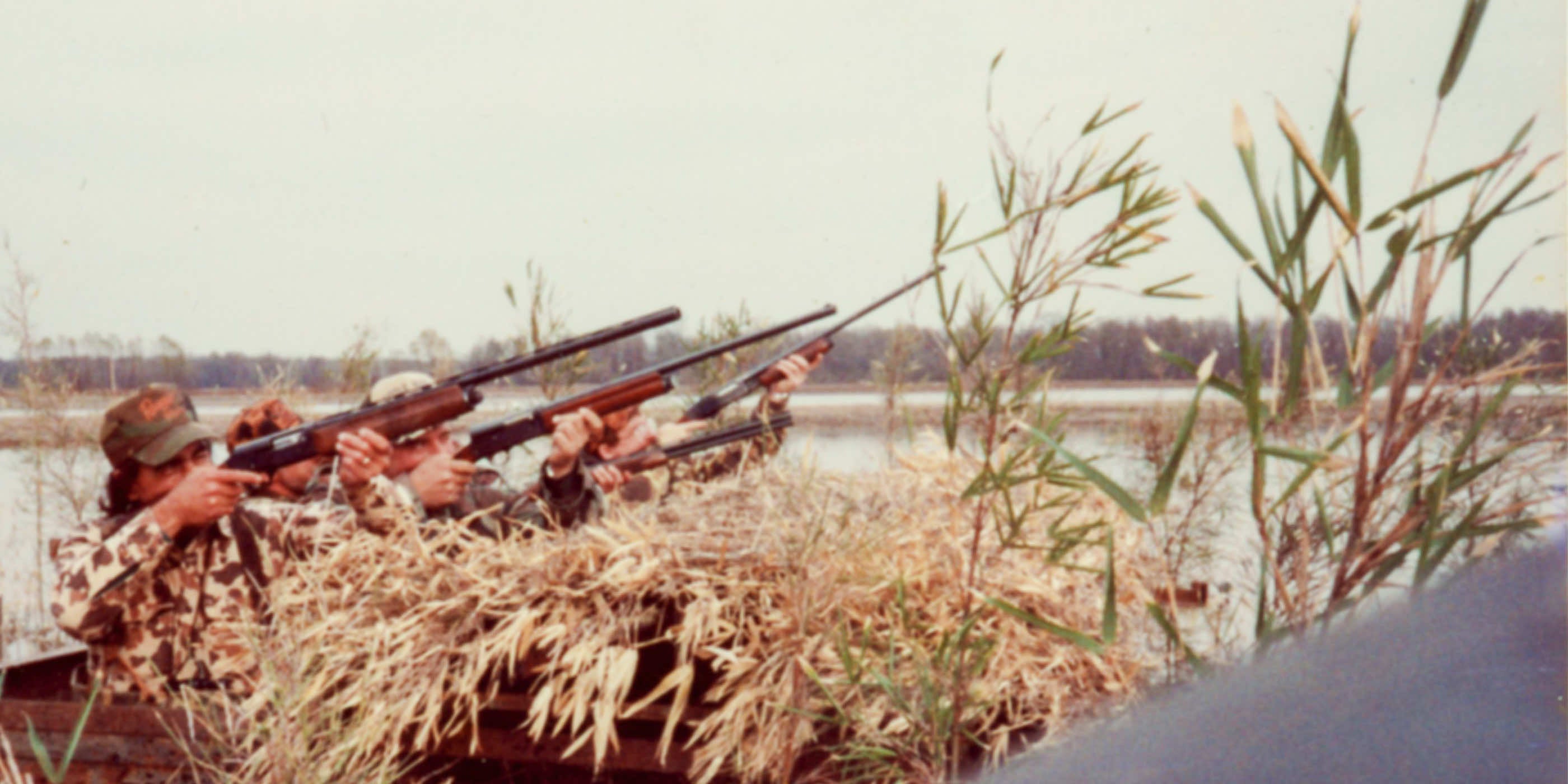 Vintage photo of hunters at Two Rivers taking aim out of a pit blind