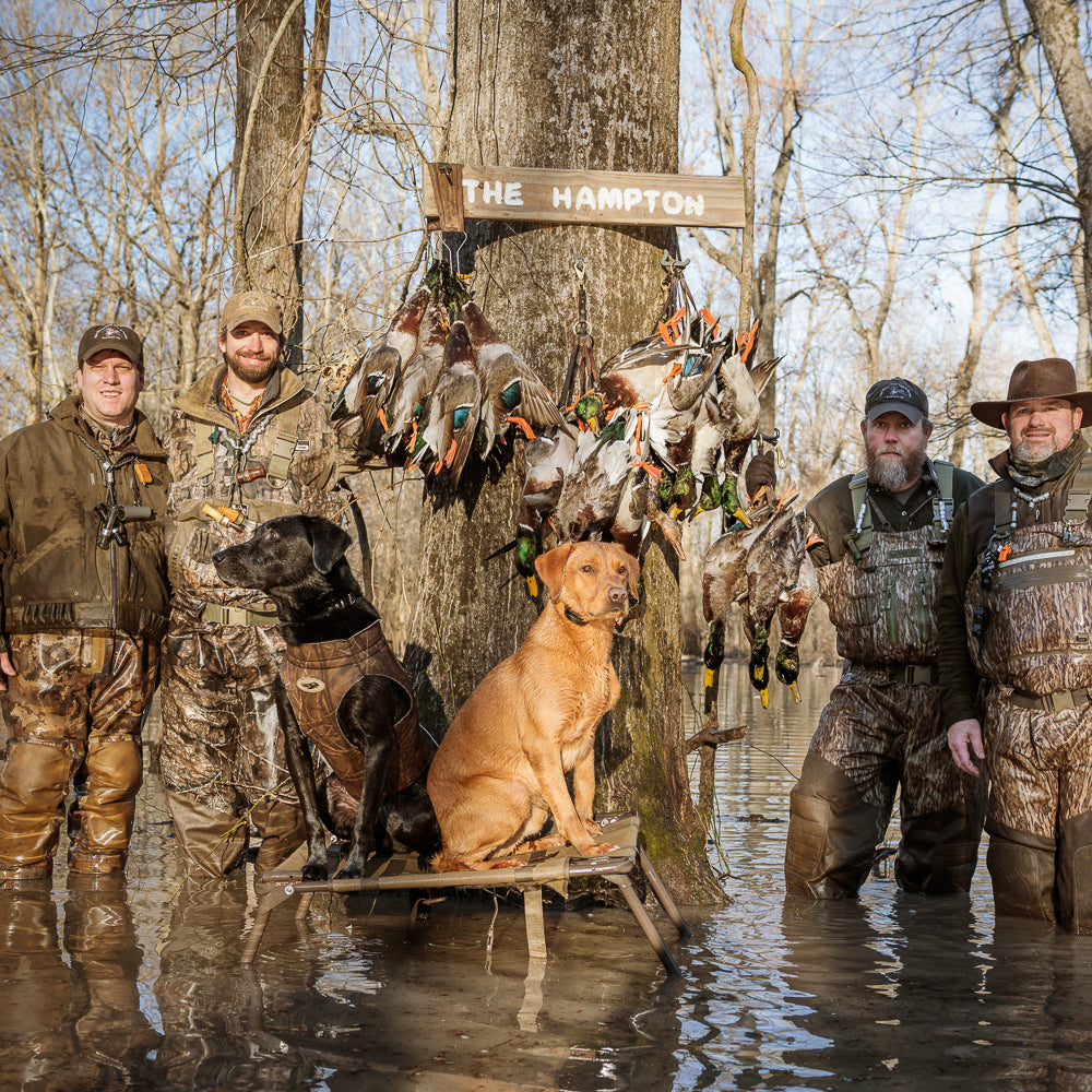 Happy hunters posing after a succesful Arkansas flooded green timber hunt at Two Rivers Duck Club.